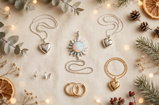 Christmas jewelry gifts for her flat lay on a warm cream background