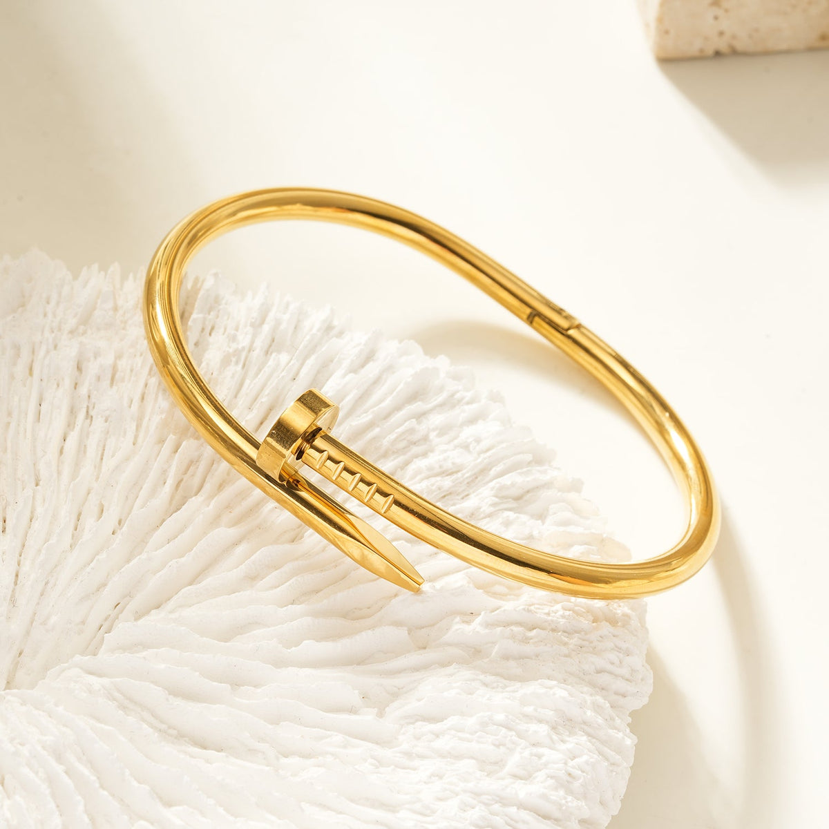 AGOTA Gold: Industrial-Chic Twisted Nail Bracelet