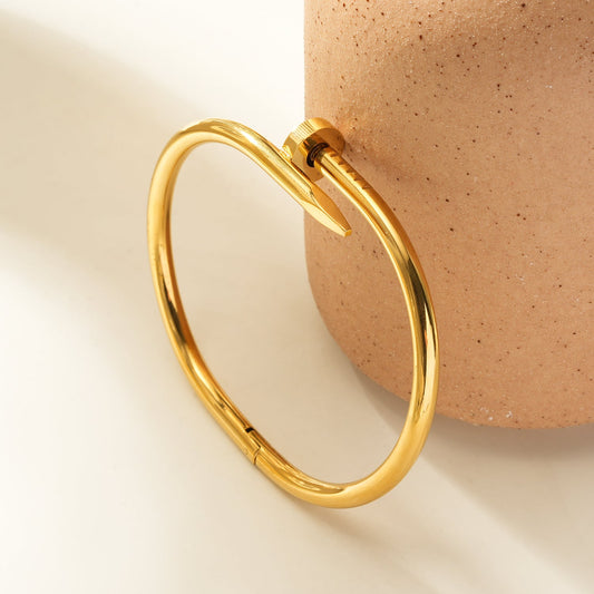 AGOTA Gold: Industrial-Chic Twisted Nail Bracelet