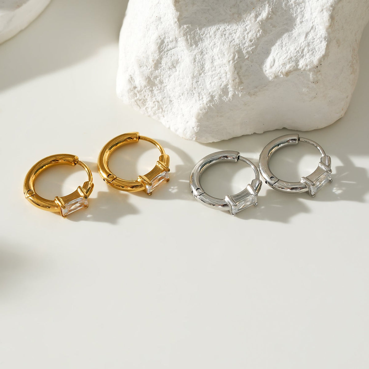 Style CONWYN: Retro Style Hoops with an Encased Clear Zirconia Charm in Gold.