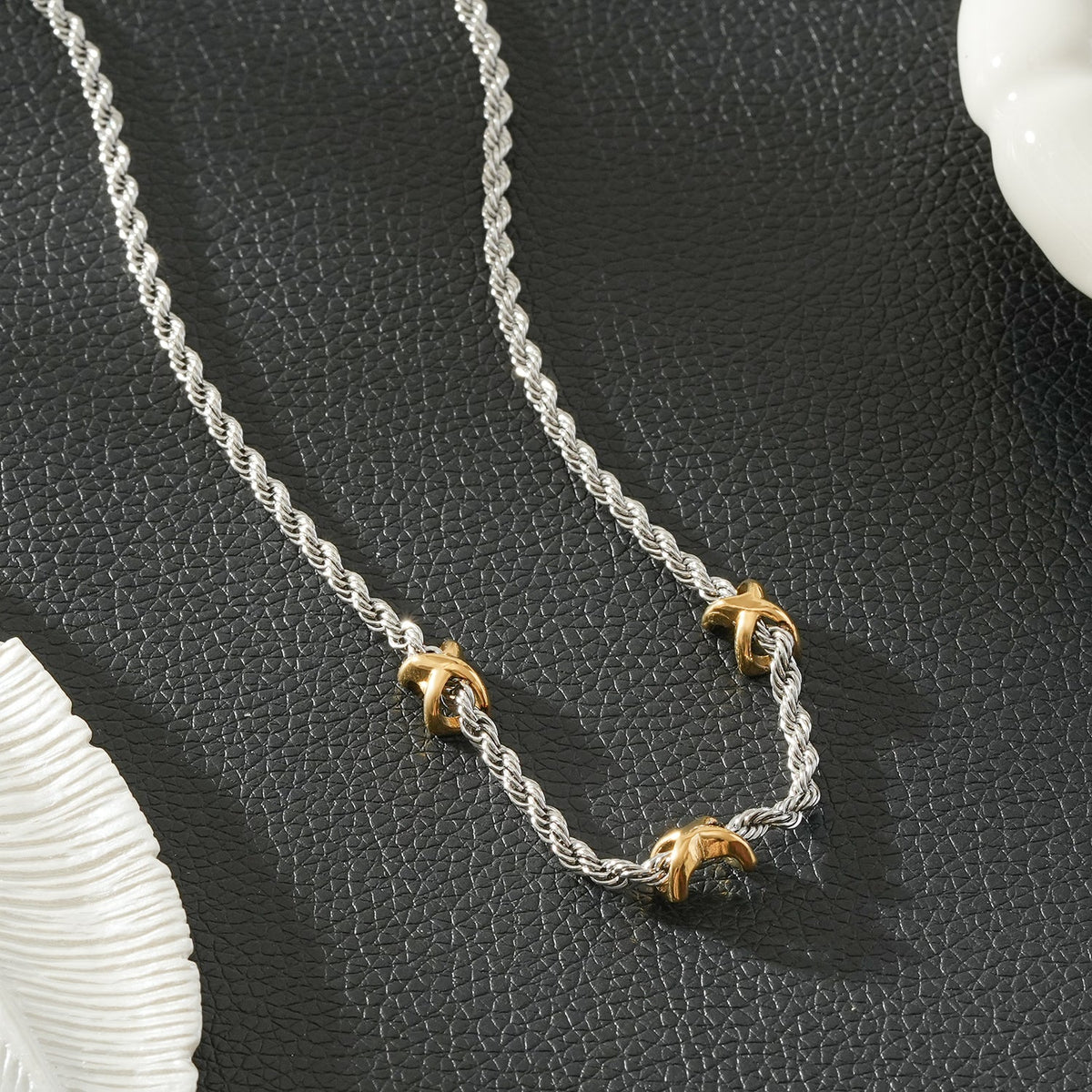 COSMINA Mixed Metals: Silver Rope Chain Necklace with Triple Mini Gold Criss-Cross Charms