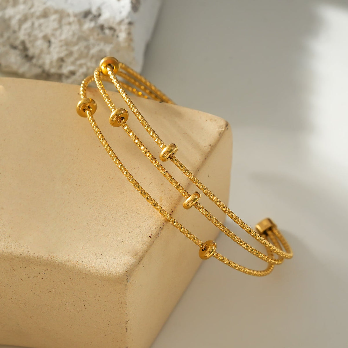 Style FARZIKA Gold: Triple Stacked Textured Beaded Bracelet